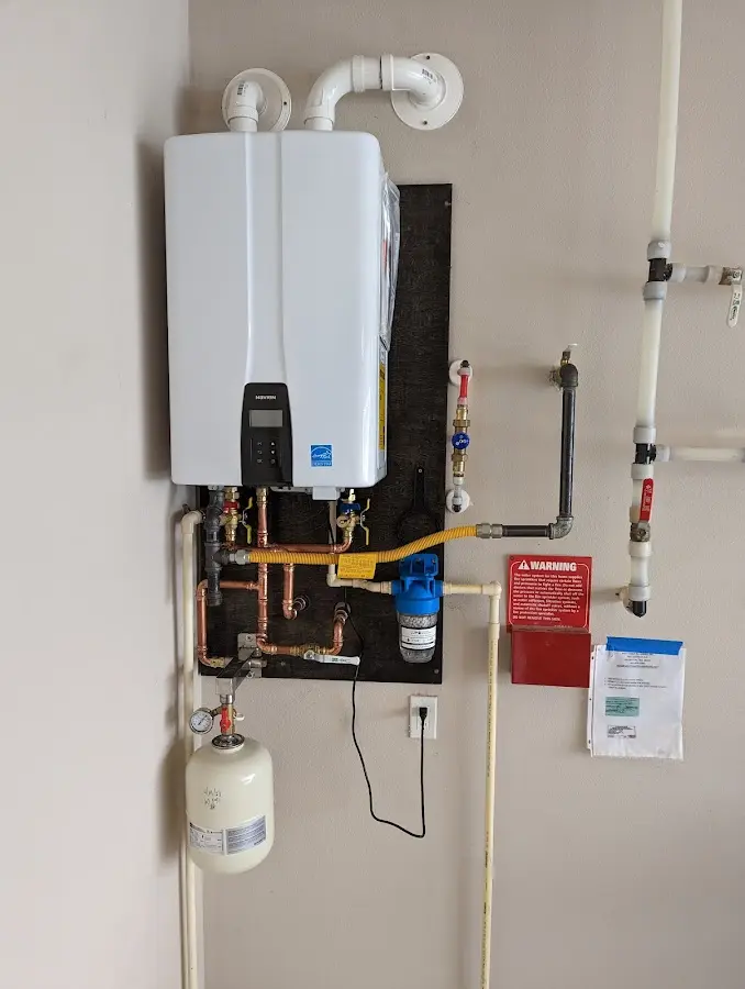 Professional plumber installing copper piping in a St. Cloud home